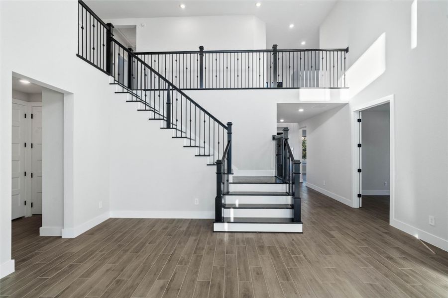 The sophisticated modern-transitional staircase makes a bold architectural statement - leading the eye up toward the expansive second-story gallery.