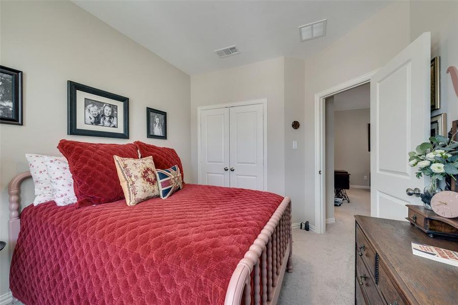 Bedroom with a closet and light carpet