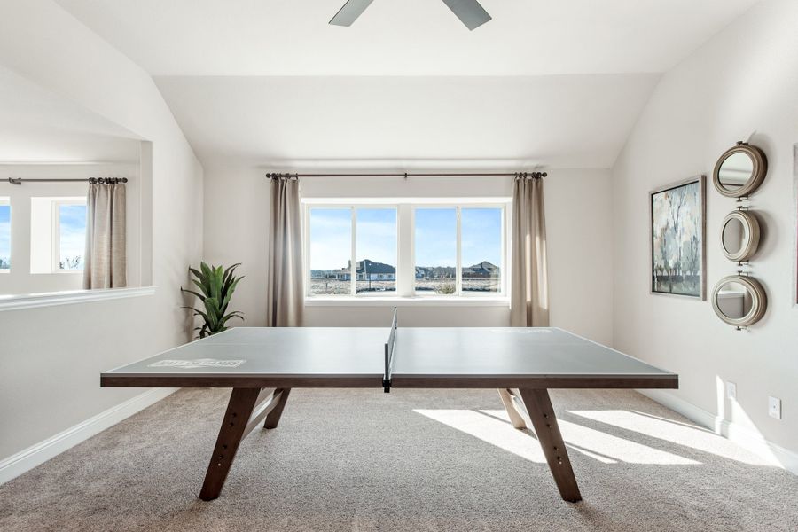 Game room with ping pong table, carpet flooring, ceiling fan, and large windows with mountain views Game room with ping pong table, carpet flooring, ceiling fan, and large windows with mountain views