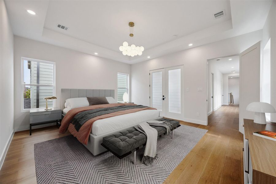 The primary bedroom balances scale and simplicity and a layout that feels comfortable for everyday living. Large windows and elevated ceilings help the room feel bright and open without feeling excessive. (digitally staged) The primary bedroom balances scale and simplicity and a layout that feels comfortable for everyday living. Large windows and elevated ceilings help the room feel bright and open without feeling excessive. (digitally staged)