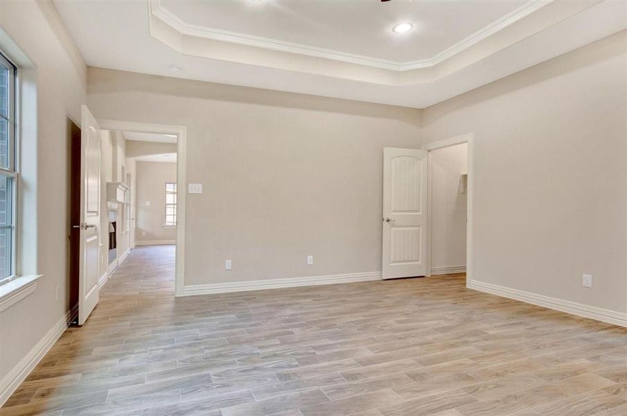 This front bedroom features three large windows that provide plenty of natural light, neutral-colored walls, wood-look tile flooring, and a ceiling fan, This front bedroom features three large windows that provide plenty of natural light, neutral-colored walls, wood-look tile flooring, and a ceiling fan,