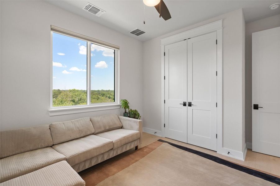 A well-lit bedroom with ample natural light offers a scenic treetop vista, creating a serene and private retreat. A well-lit bedroom with ample natural light offers a scenic treetop vista, creating a serene and private retreat.
