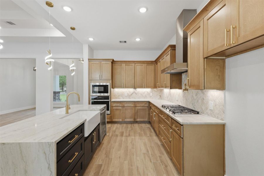 Countertop and cabinet space galore! Plus built-in oven and microwave and chef kitchen inspired vent hood and pot filler!
