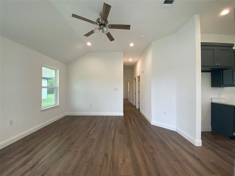 Living room with recessed lighting, dark wood-style flooring, and a ceiling fan Living room with recessed lighting, dark wood-style flooring, and a ceiling fan