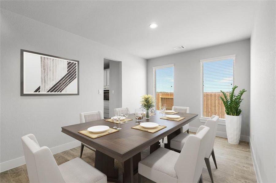 Make memories gathered around the table with your family and friends! This spacious dining room features elegant flooring, custom paint, and adjacent to family room and kitchen for open concept feel. Sample photo of completed home with similar floor plan. As-built interior colors and selections may vary.