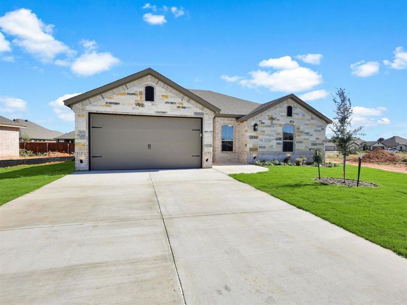 Front exterior of a new home in , Springtown, TX, highlighting curb appeal (Image 1). Front exterior of a new home in , Springtown, TX, highlighting curb appeal (Image 1).