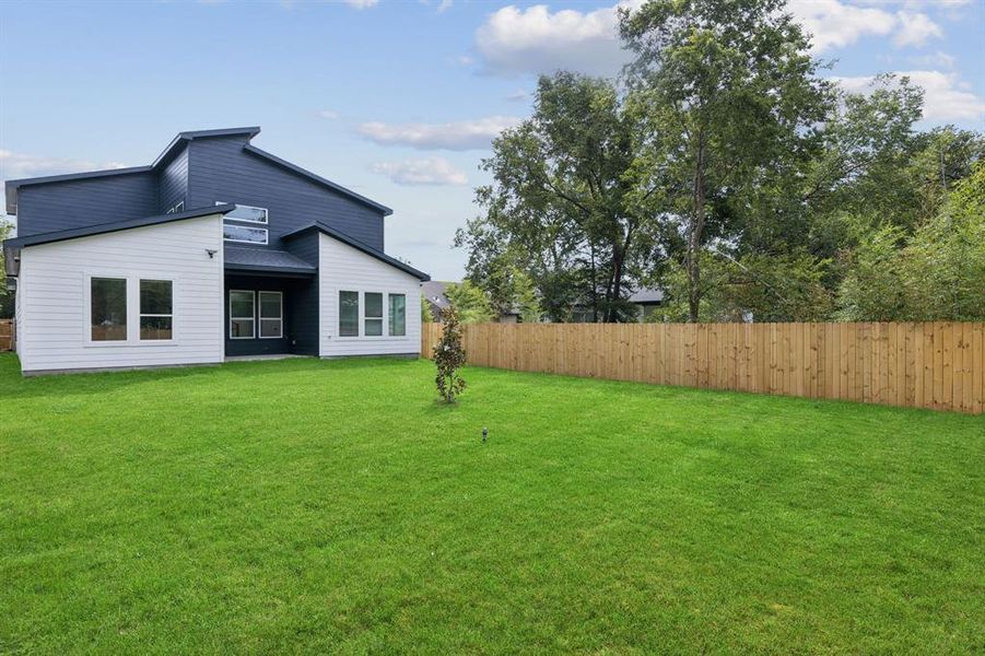 Back of house featuring a fenced backyard