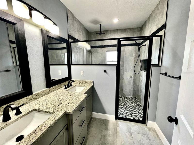 primary bathroom- granite counter with his and her sinks. primary bathroom- granite counter with his and her sinks.