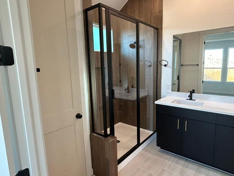 Bathroom with vanity and a shower stall