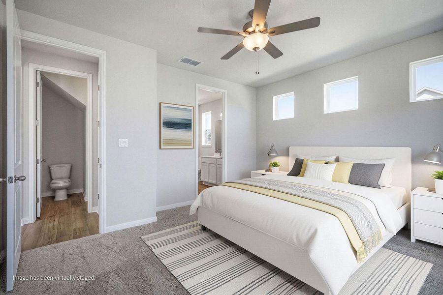 An inviting atmosphere highlights this comfortable bedroom featuring soft carpeting and high-set windows. An inviting atmosphere highlights this comfortable bedroom featuring soft carpeting and high-set windows.