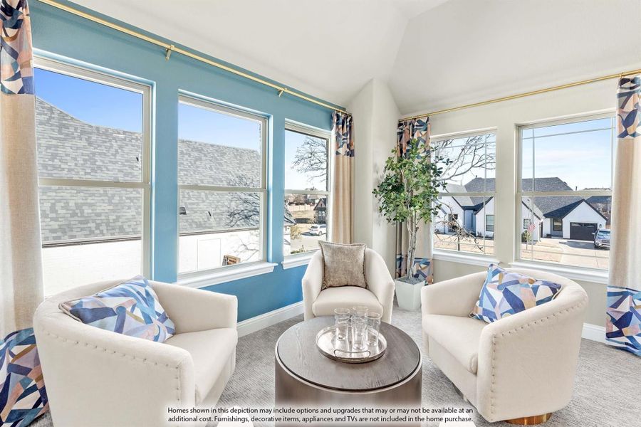 Bright sitting room with three white armchairs, round coffee table, and large windows with blue accent wall Bright sitting room with three white armchairs, round coffee table, and large windows with blue accent wall