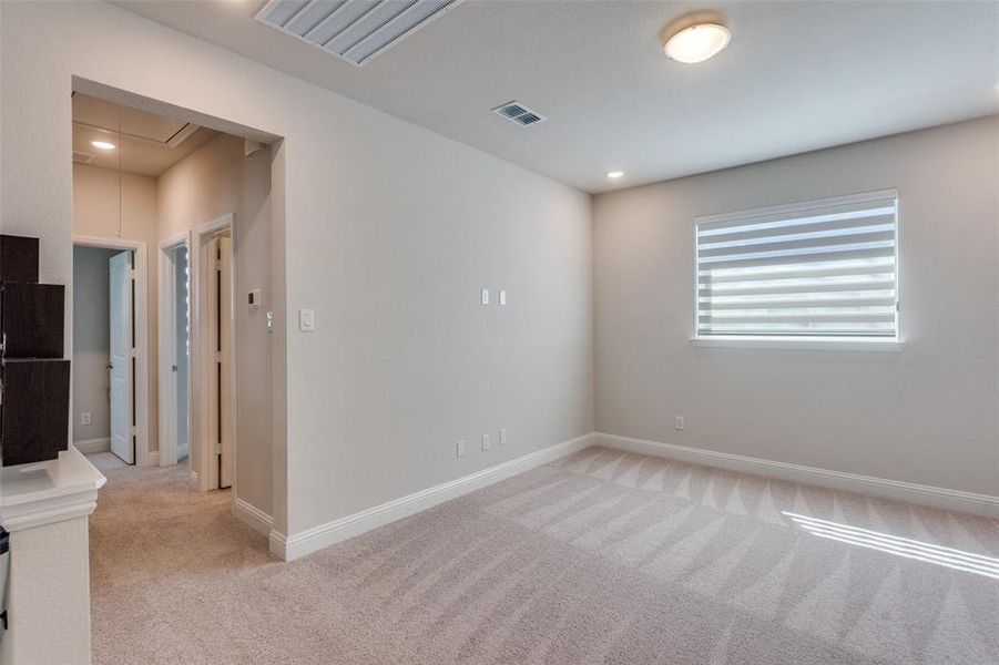 Empty room with attic access, light colored carpet, and recessed lighting Empty room with attic access, light colored carpet, and recessed lighting