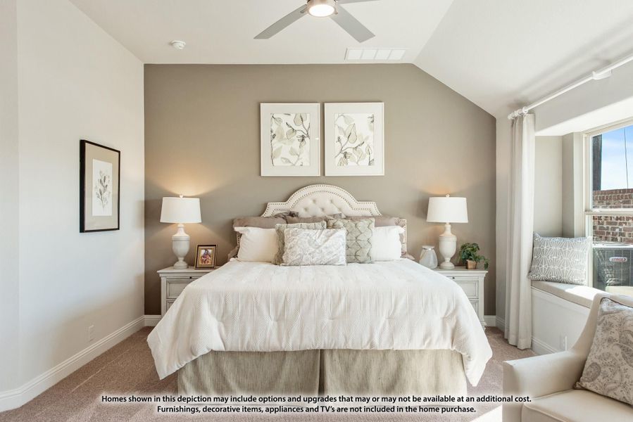 Bedroom with vaulted ceiling, ceiling fan, neutral accent wall, and window seat Bedroom with vaulted ceiling, ceiling fan, neutral accent wall, and window seat