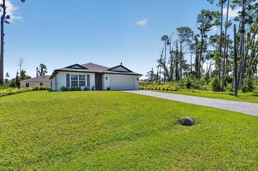 Front exterior of a new home in , North Port, FL, highlighting curb appeal (Image 24). Front exterior of a new home in , North Port, FL, highlighting curb appeal (Image 24).