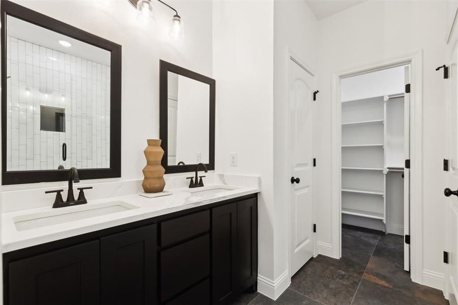 Bathroom featuring vanity and a shower with door