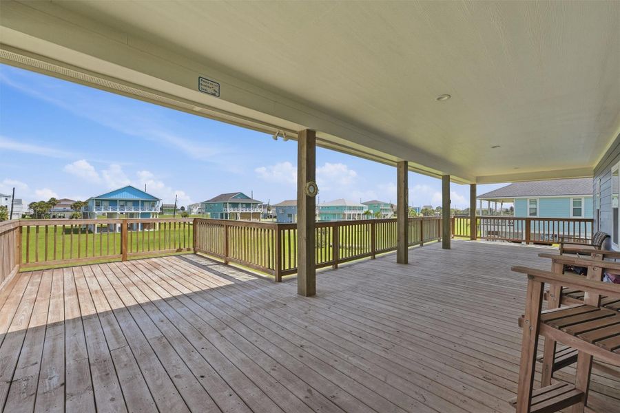 Expansive covered deck with wooden flooring offers a perfect space for outdoor relaxation and entertaining, boasting scenic views of the surrounding neighborhood. Expansive covered deck with wooden flooring offers a perfect space for outdoor relaxation and entertaining, boasting scenic views of the surrounding neighborhood.