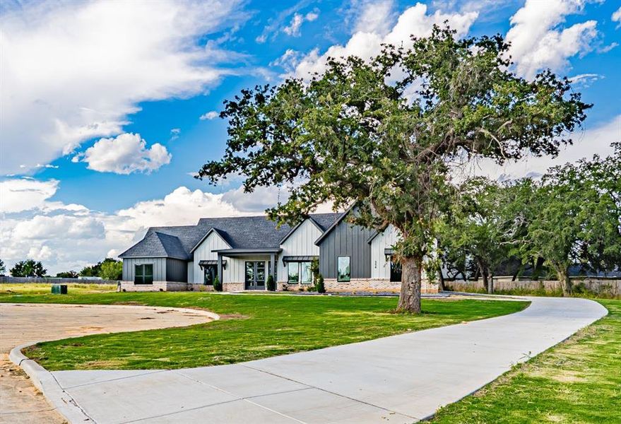 Front exterior of a new home in , Granbury, TX, highlighting curb appeal (Image 23). Front exterior of a new home in , Granbury, TX, highlighting curb appeal (Image 23).
