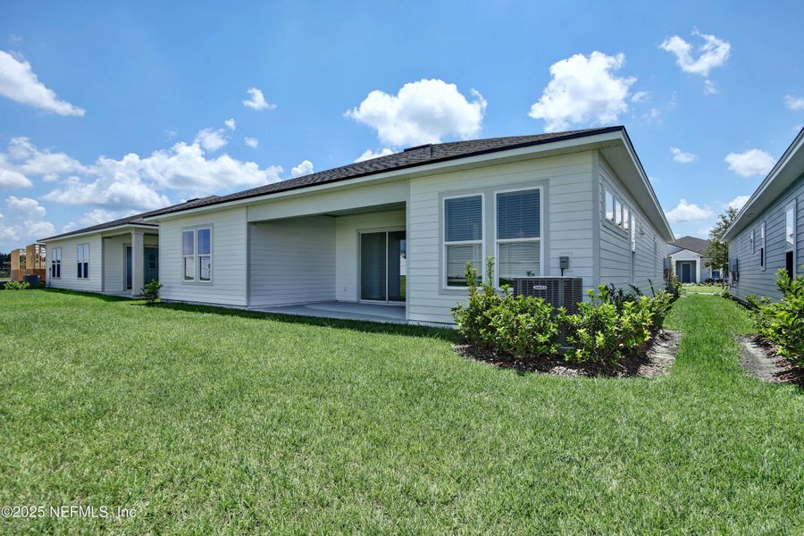 Front exterior of a new home in Reverie at Silverleaf, St. Augustine, FL, highlighting curb appeal (Image 14).