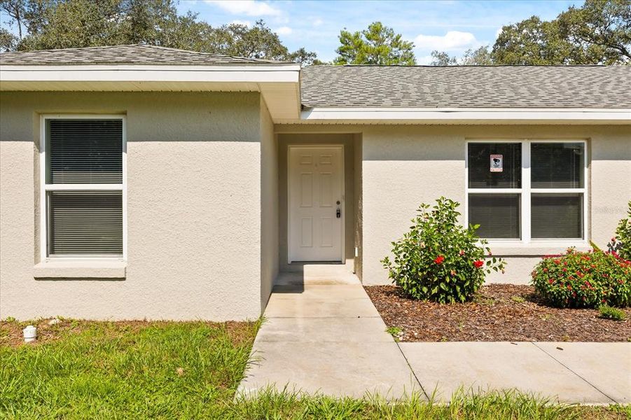 Front exterior of a new home in , Ocklawaha, FL, highlighting curb appeal (Image 19).