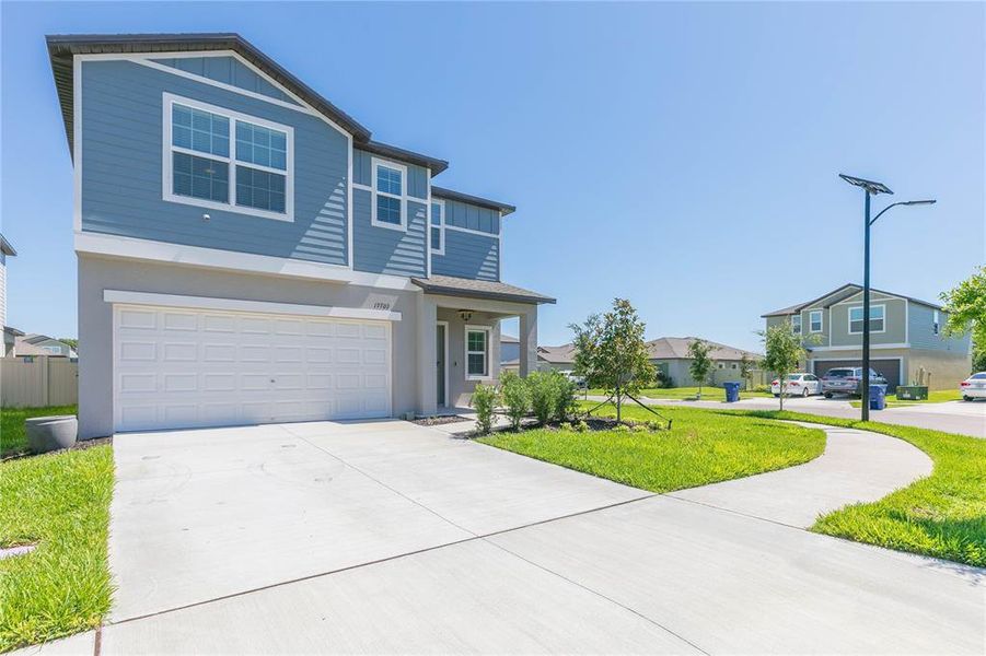 Front exterior of a new home in Angeline, Land O' Lakes, FL, highlighting curb appeal (Image 26).