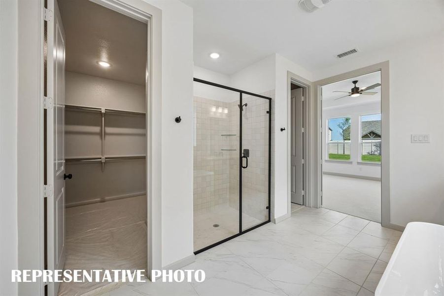 Featuring a free standing tub with spacious walk in shower and his & hers closets, you will love this fantastic owner's bath!  REPRESENTATIVE PHOTO
