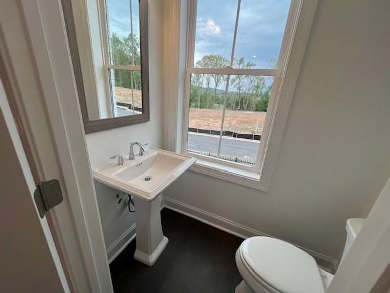 Bathroom featuring toilet and wood finished floors