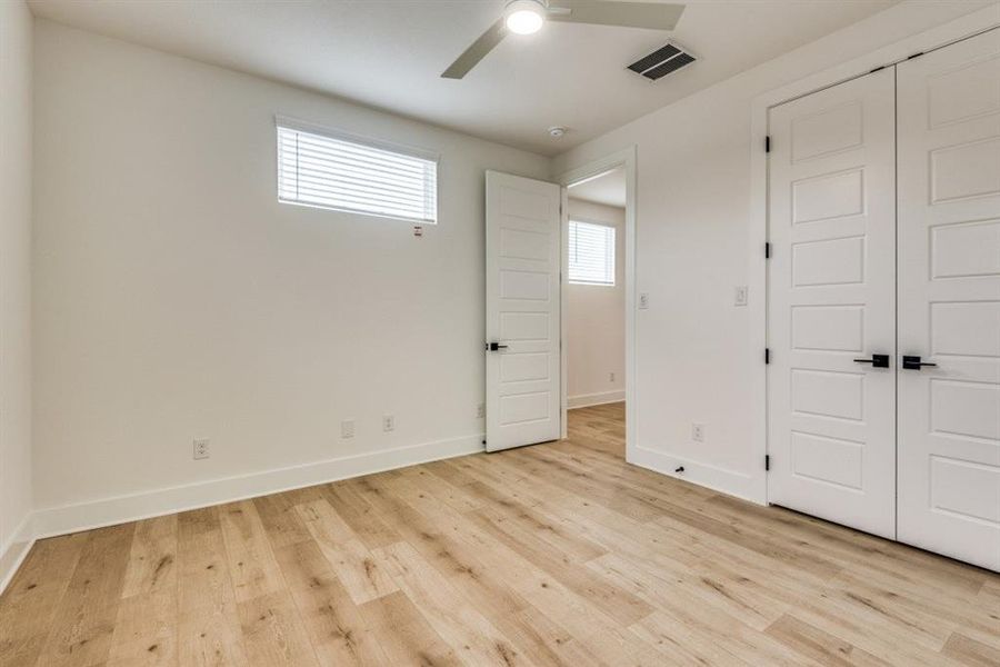 Unfurnished bedroom with a closet, ceiling fan, and light hardwood / wood-style flooring