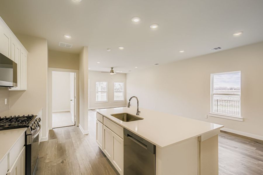 A kitchen with white cabinets.