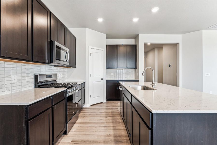 A kitchen with black cabinets.