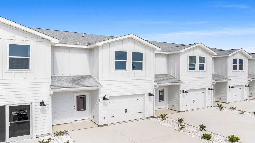 Front exterior of a new home in WindMark Beach, Port Saint Joe, FL, highlighting curb appeal (Image 2). Front exterior of a new home in WindMark Beach, Port Saint Joe, FL, highlighting curb appeal (Image 2).