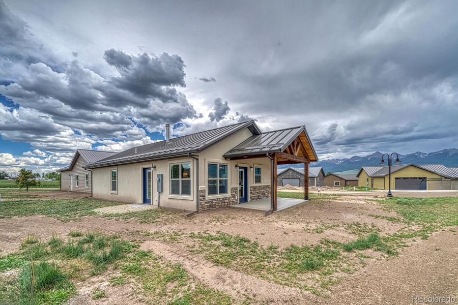Front exterior of a new home in , Silver Cliff, CO, highlighting curb appeal (Image 20).