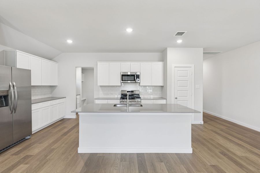 Kitchen in the Harrison home plan by Trophy Signature Homes – REPRESENTATIVE PHOTO