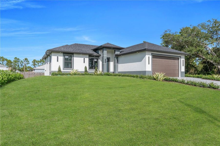 Front exterior of a new home in , Lehigh Acres, FL, highlighting curb appeal (Image 25).