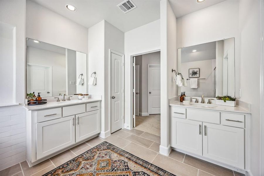 Indulge in the opulence of the spa-like Primary Bath, where dual vanities meet striking quartz—a daily luxury.