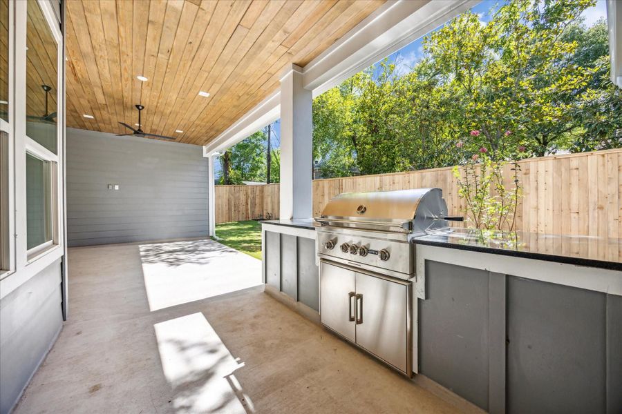 Covered back patio with gas grill