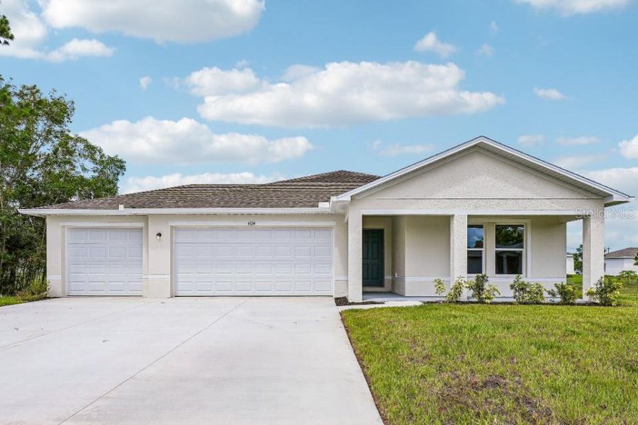 Front exterior of a new home in Burnt Store Village, Punta Gorda, FL, highlighting curb appeal (Image 1). Front exterior of a new home in Burnt Store Village, Punta Gorda, FL, highlighting curb appeal (Image 1).
