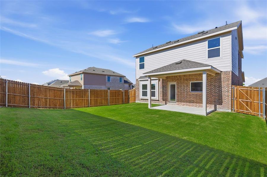Expansive backyard featuring a lush lawn and a wood privacy fence
