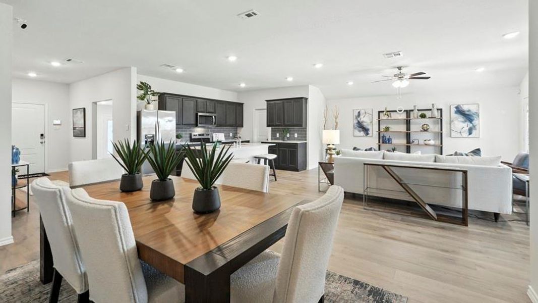 Dining space featuring light wood-style floors, recessed lighting, and a ceiling fan Dining space featuring light wood-style floors, recessed lighting, and a ceiling fan