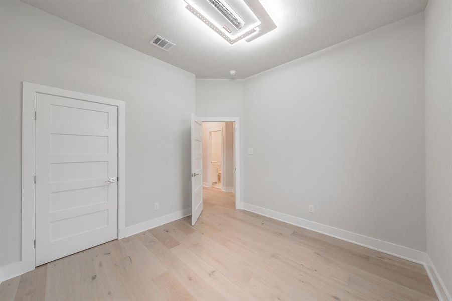Unfurnished bedroom featuring light wood-style floors and baseboards