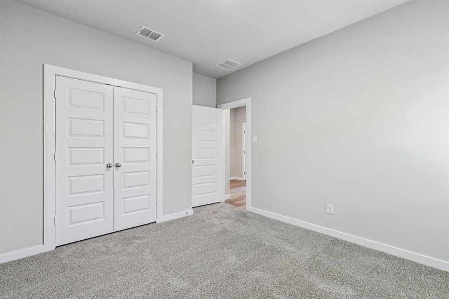 Bedroom in the Heisman home plan by Trophy Signature Homes – REPRESENTATIVE PHOTO Bedroom in the Heisman home plan by Trophy Signature Homes – REPRESENTATIVE PHOTO