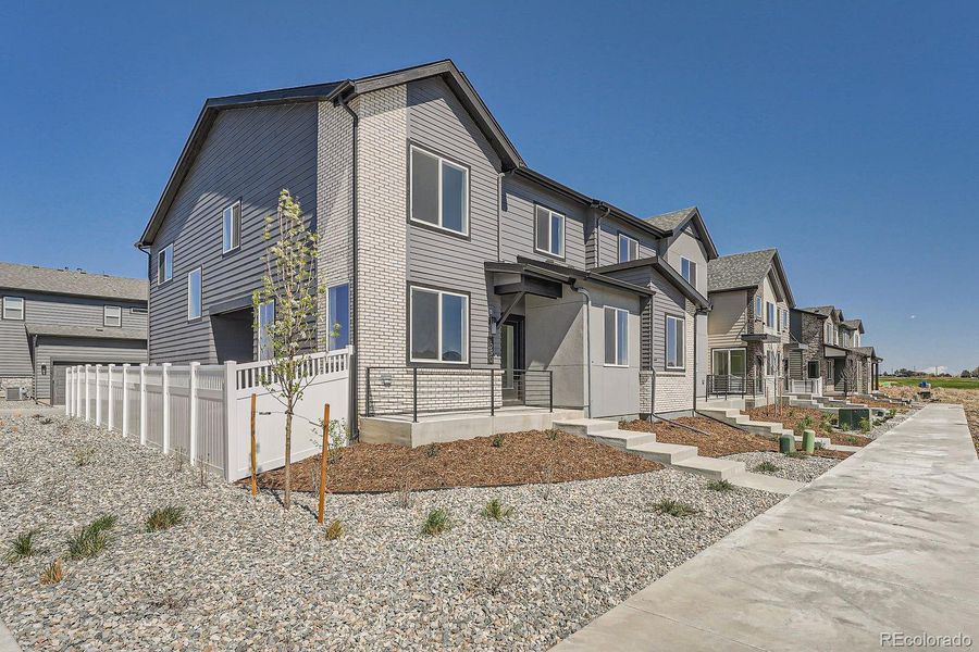 Front exterior of a new home in Elevations at Murphy Creek, Aurora, CO, highlighting curb appeal (Image 1).