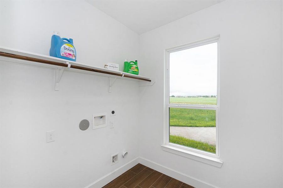 Laundry area with plenty of natural lighting and easy access from the kitchen.