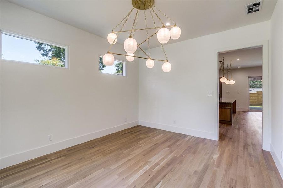 Spare room with light wood-type flooring and baseboards Spare room with light wood-type flooring and baseboards