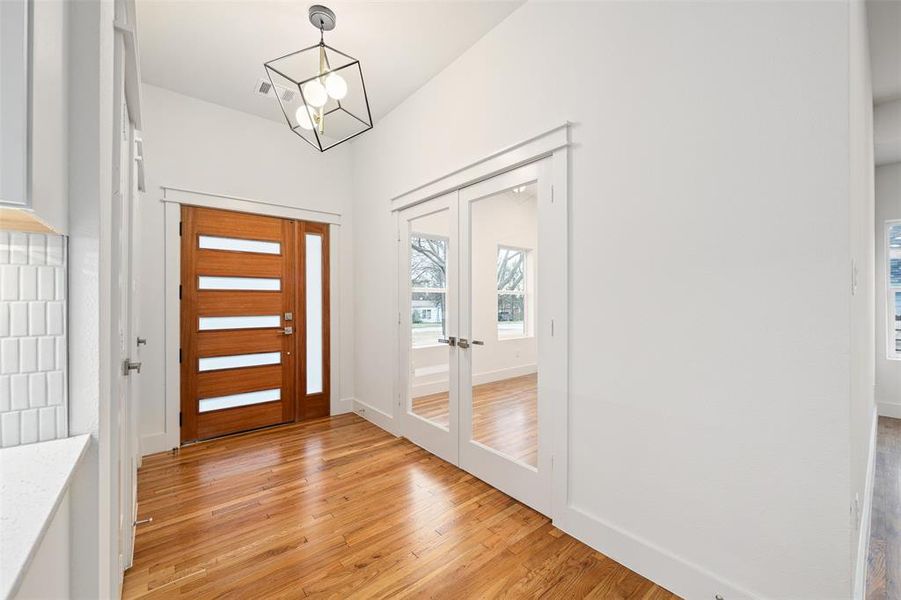 Entryway with visible vents, french doors, light wood-type flooring, and baseboards