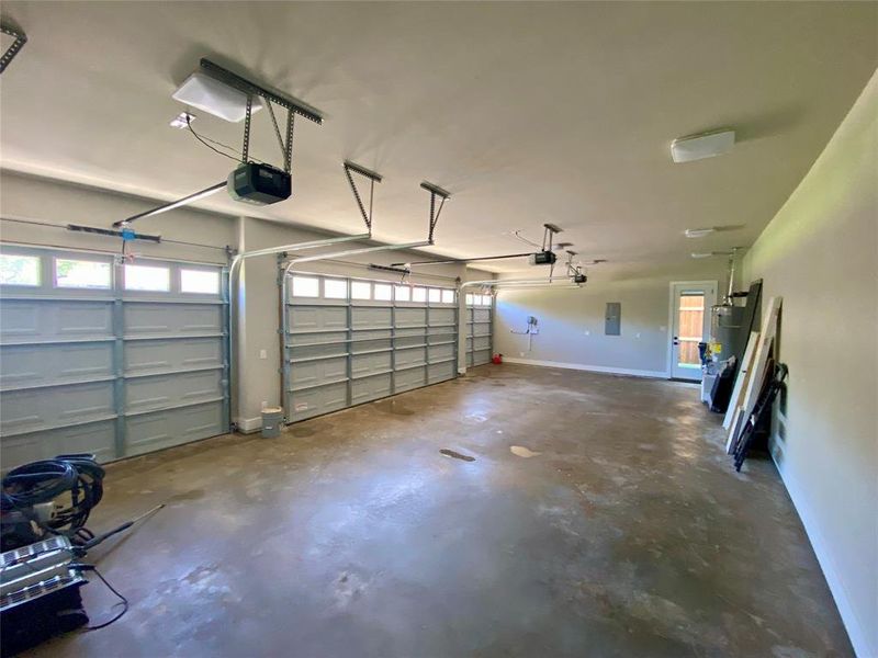 Garage with a garage door opener and gas water heater