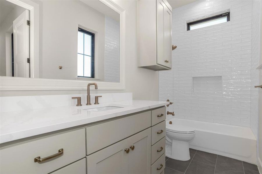 Full bathroom with vanity, shower / bath combination, and dark tile patterned flooring Full bathroom with vanity, shower / bath combination, and dark tile patterned flooring