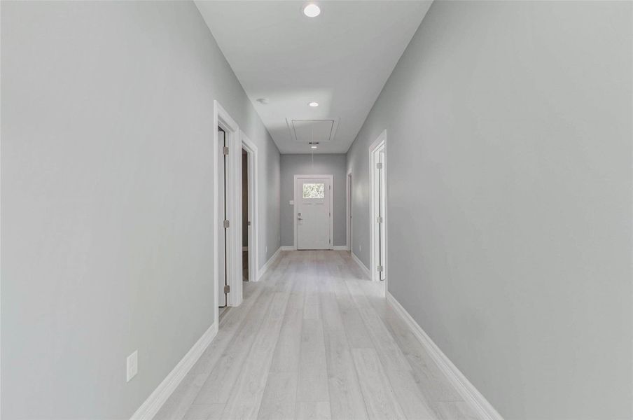 Bright hallway with a clear view leading directly to the backyard