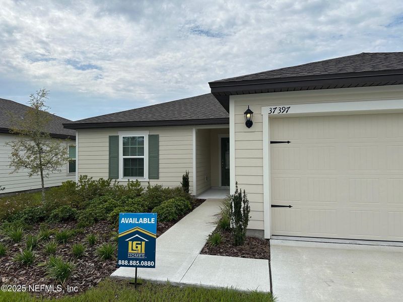 Front exterior of a new home in Whisper Ridge, Hilliard, FL, highlighting curb appeal (Image 10). Front exterior of a new home in Whisper Ridge, Hilliard, FL, highlighting curb appeal (Image 10).