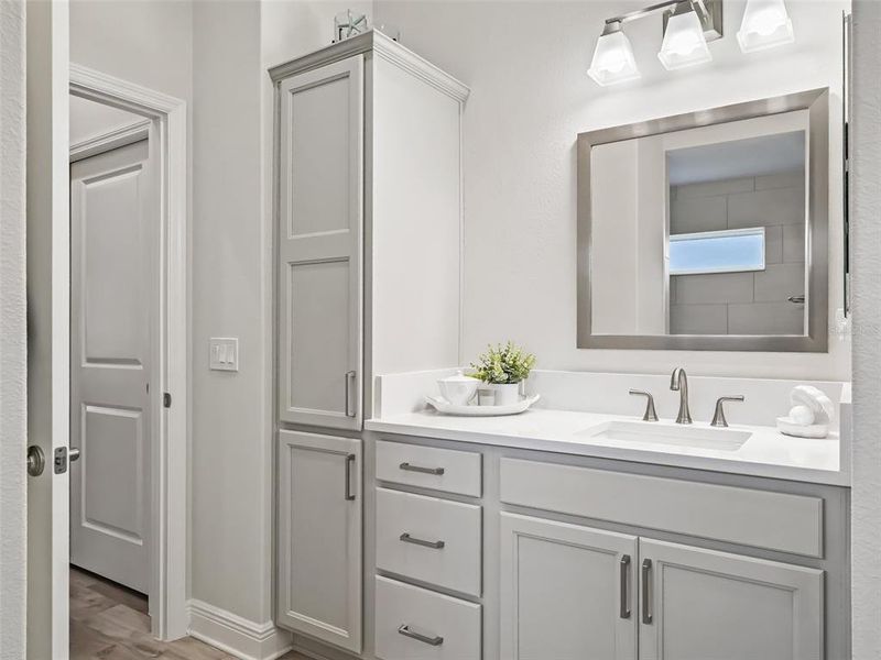 Primary Bath with dual sinks, water closet, and roman shower