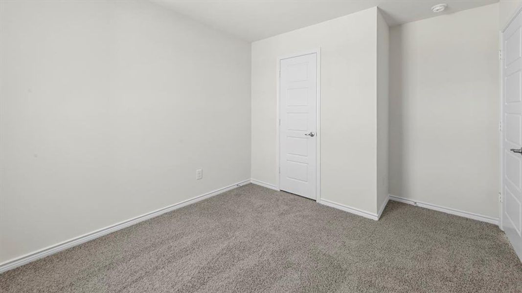 Room featuring gray carpeting and white painted walls
